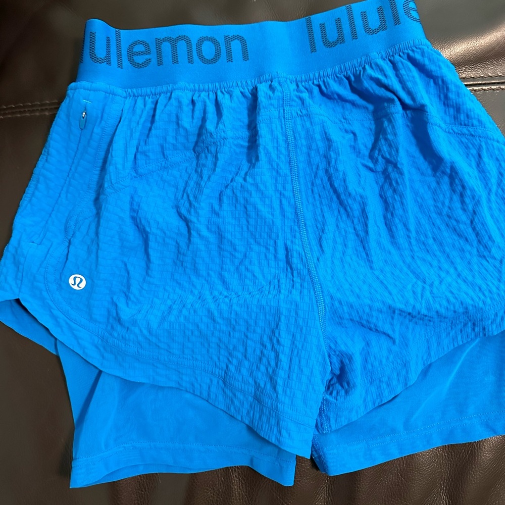 Bright blue running shorts w/ attached inner bike shorts, size 4